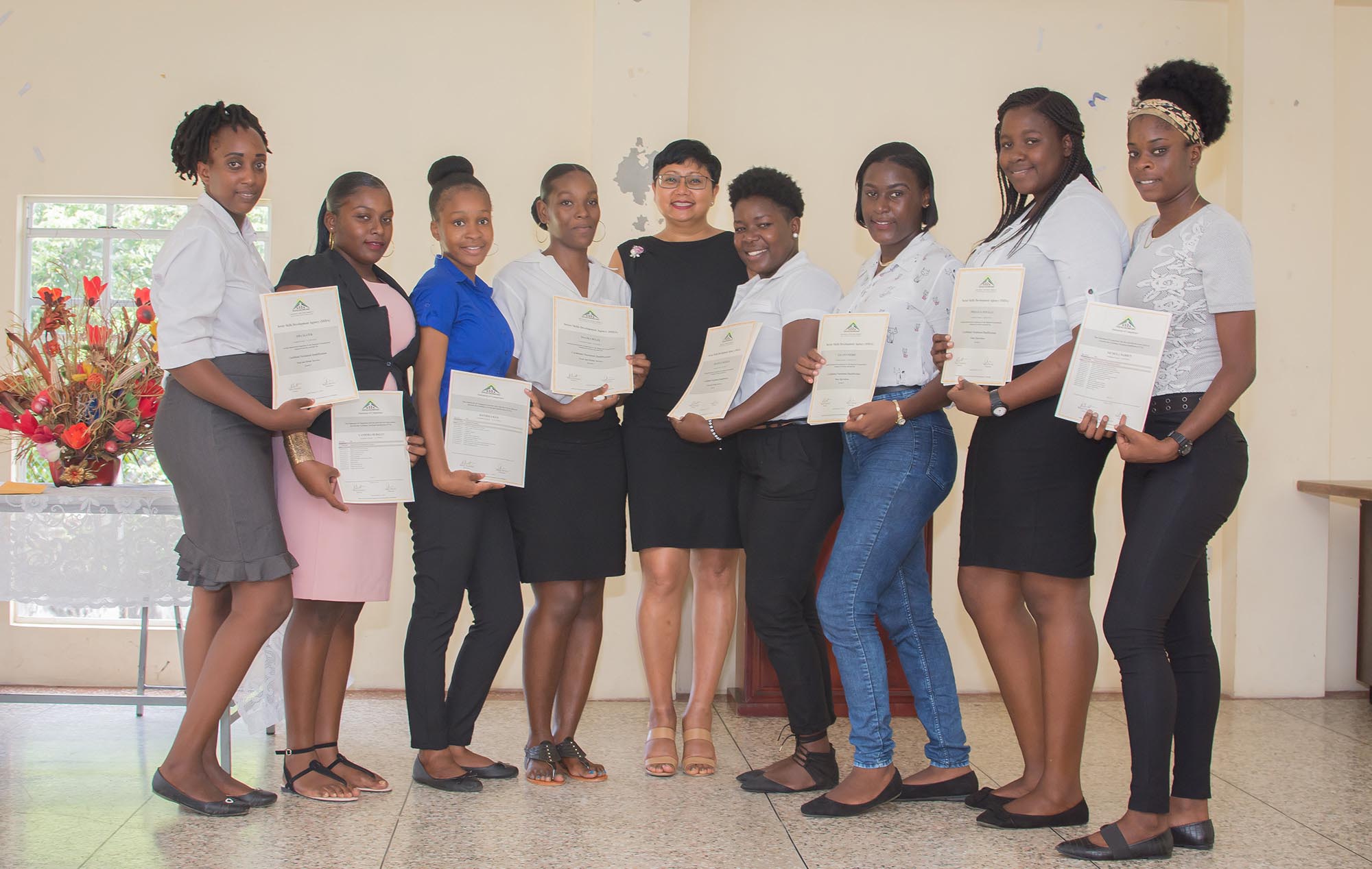 Dularie Malcolm of the Mustique Charitable Foundation (centre) with some of the female graduates.