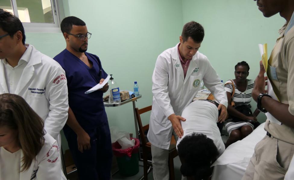 Clinic evaluation observing patient’s spine when extended