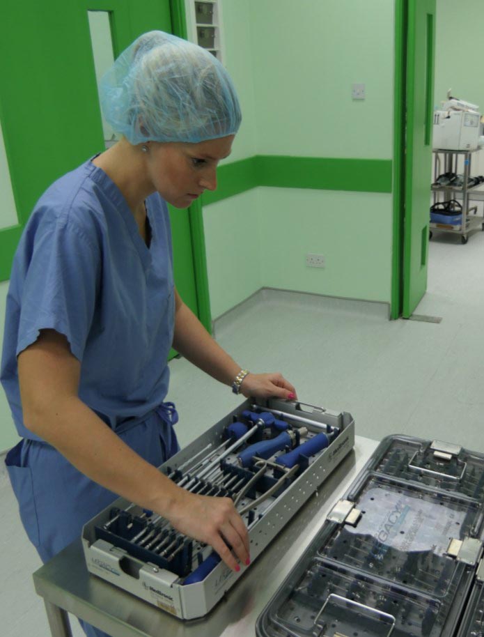 Medtronic representative Caitlyn Mabry prepares the needed hardware selection for a patient